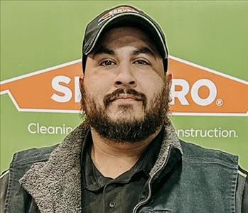 SERVPRO employee in front of green background